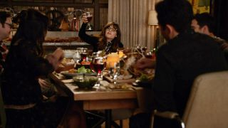 Zooey Deschanel toasted at a dinner table in New Girl. 