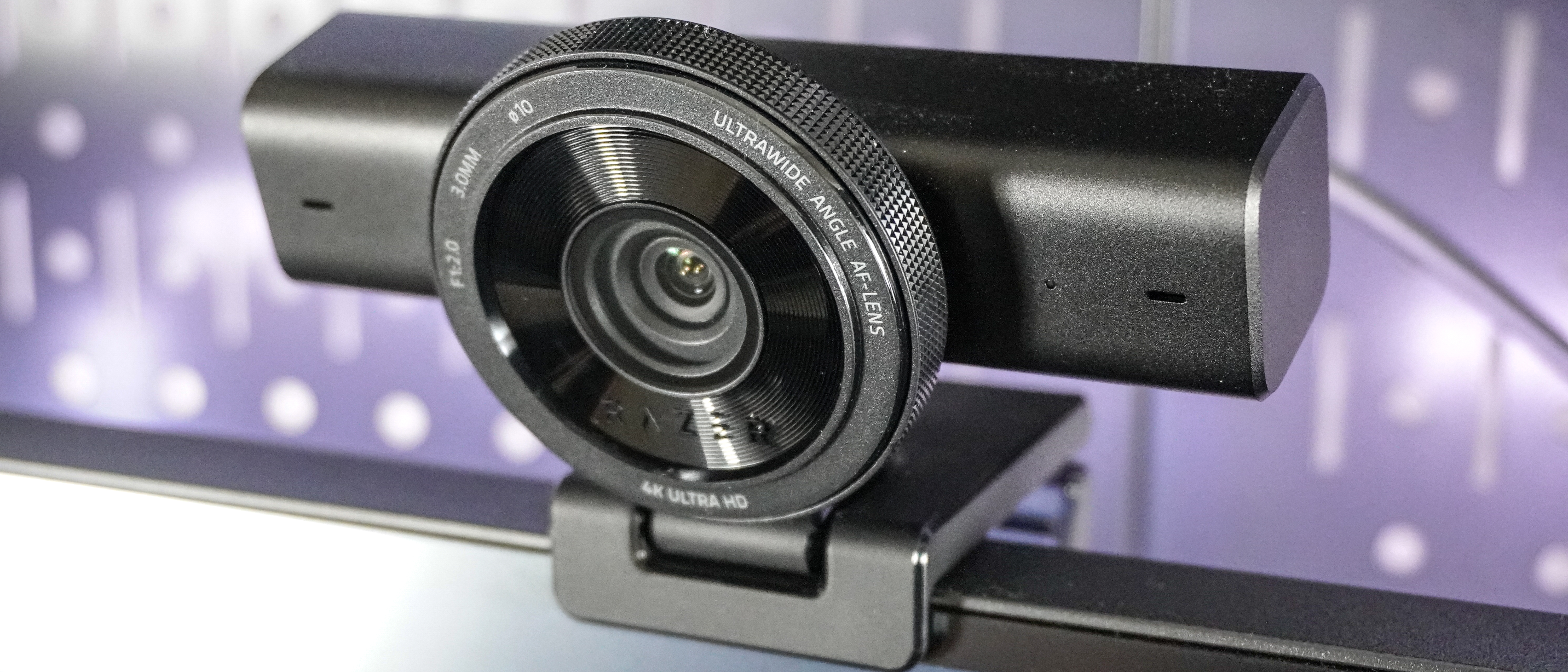 The Razer Kiyo V2 webcam perched on top of a monitor with pegboard behind it