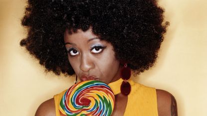 Hairstyle, Jheri curl, Candy, Afro, Style, Confectionery, Earrings, Hard candy, Stick candy, Black hair, 
