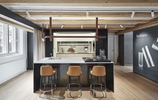 Kitchen island by Arclinea with three leather upholstered stools