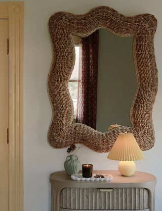 Woven banana leaf boho chic statement wall mirror from Anthropologie.