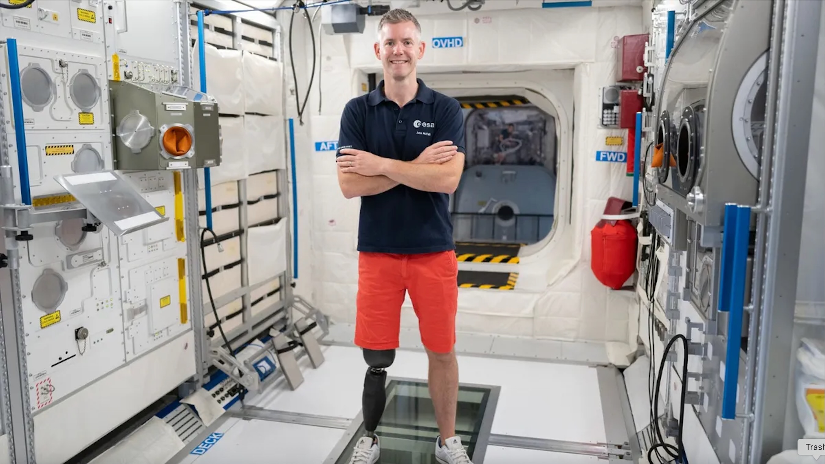 John McFall, a reserve astronaut with the European Space Agency, standing in a mockup International Space Station module.