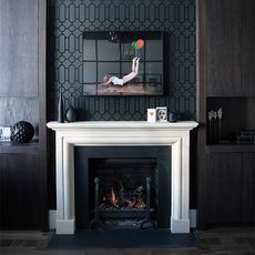 black designed wall with frame and white frame fire pit