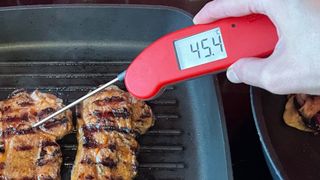 The ThermoWorks Thermapen One being used to check the temperature of steak