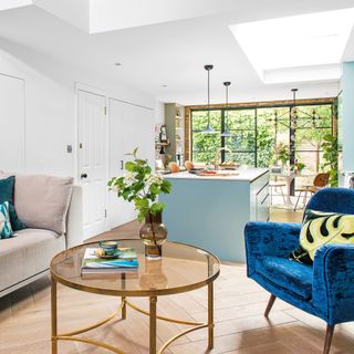 Open plan living space with armchair and kitchen island