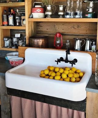 Vintage white sink filled with lemons