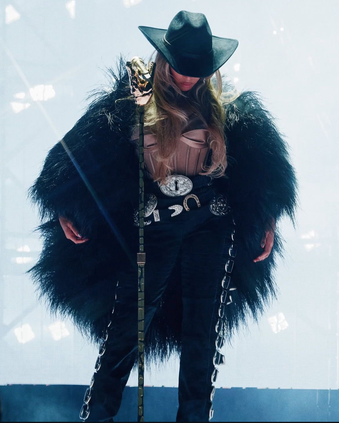 Beyoncé in a feather-embellished custom look from Schiaparelli on the Cowboy Carter tour.