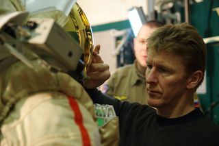 British astronaut Tim Peake works with a Russian Orlan spacesuit.