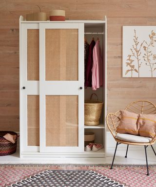 wardrobe with clothes and carpet on floor