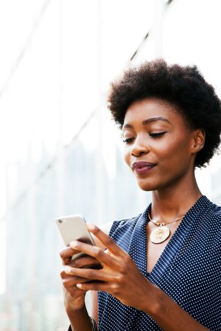 woman looking at her iPhone