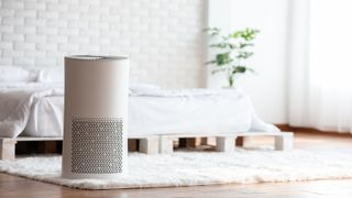 Air purifier in cozy white bed room for filter and cleaning removing dust