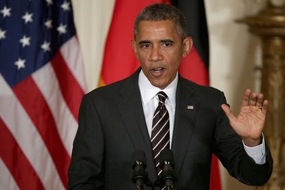 President Obama speaks at a news conference with German Chancellor Angela Merkel.