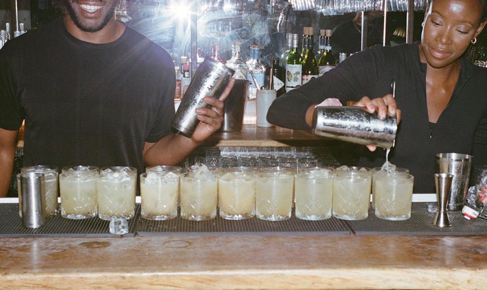 Two people making drinks