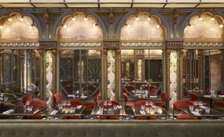 Beefbar interior with gold marble pilasters and stained glass arches