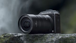 Hasselblad XCD 20-35mm f/3.2-4.5 E lens attached to the X2D 100C camera, on a rock by a waterfall