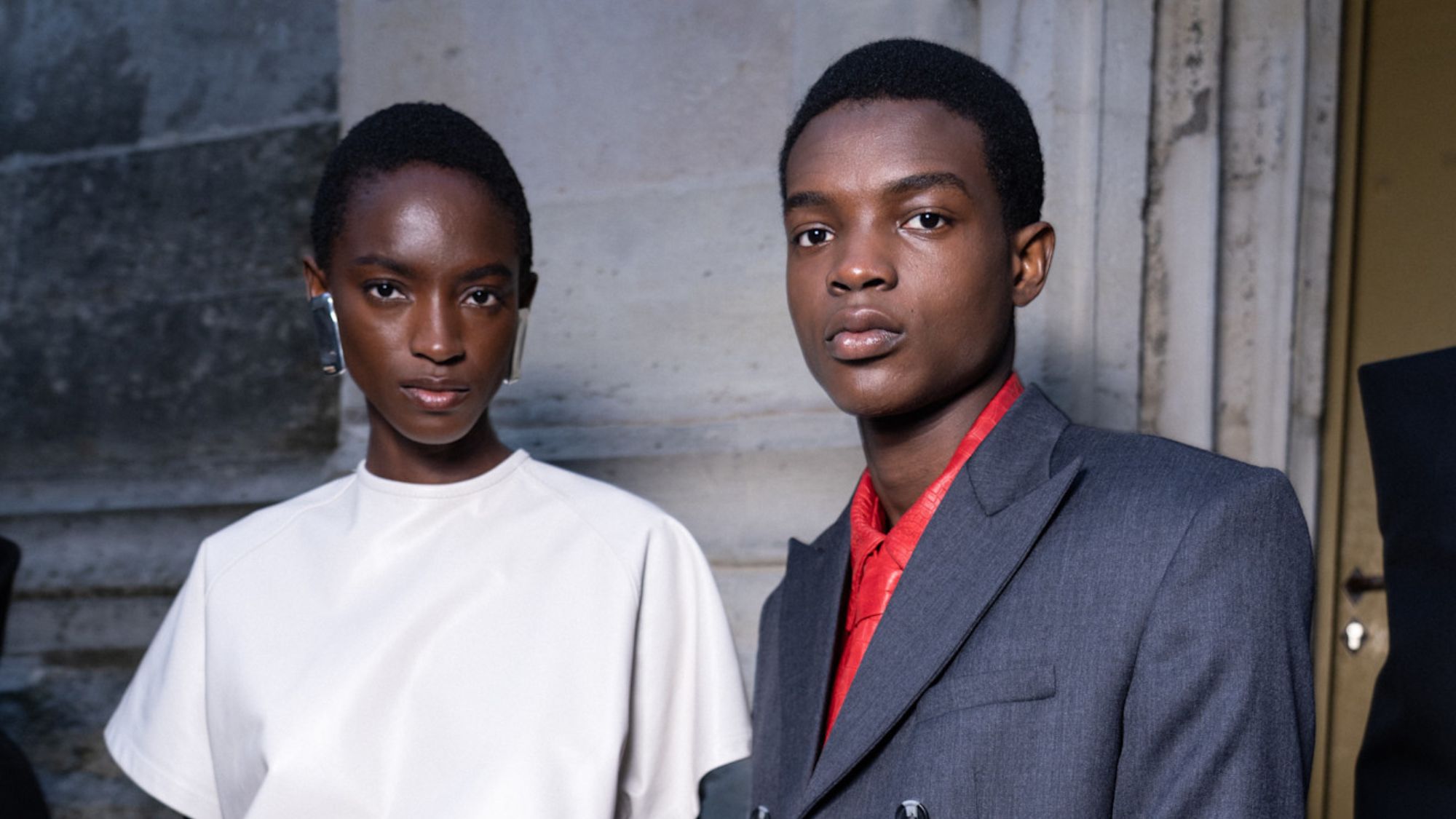 male and female models backstage at fashion week
