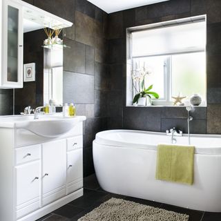 bathroom with mirror with basin and bathtub