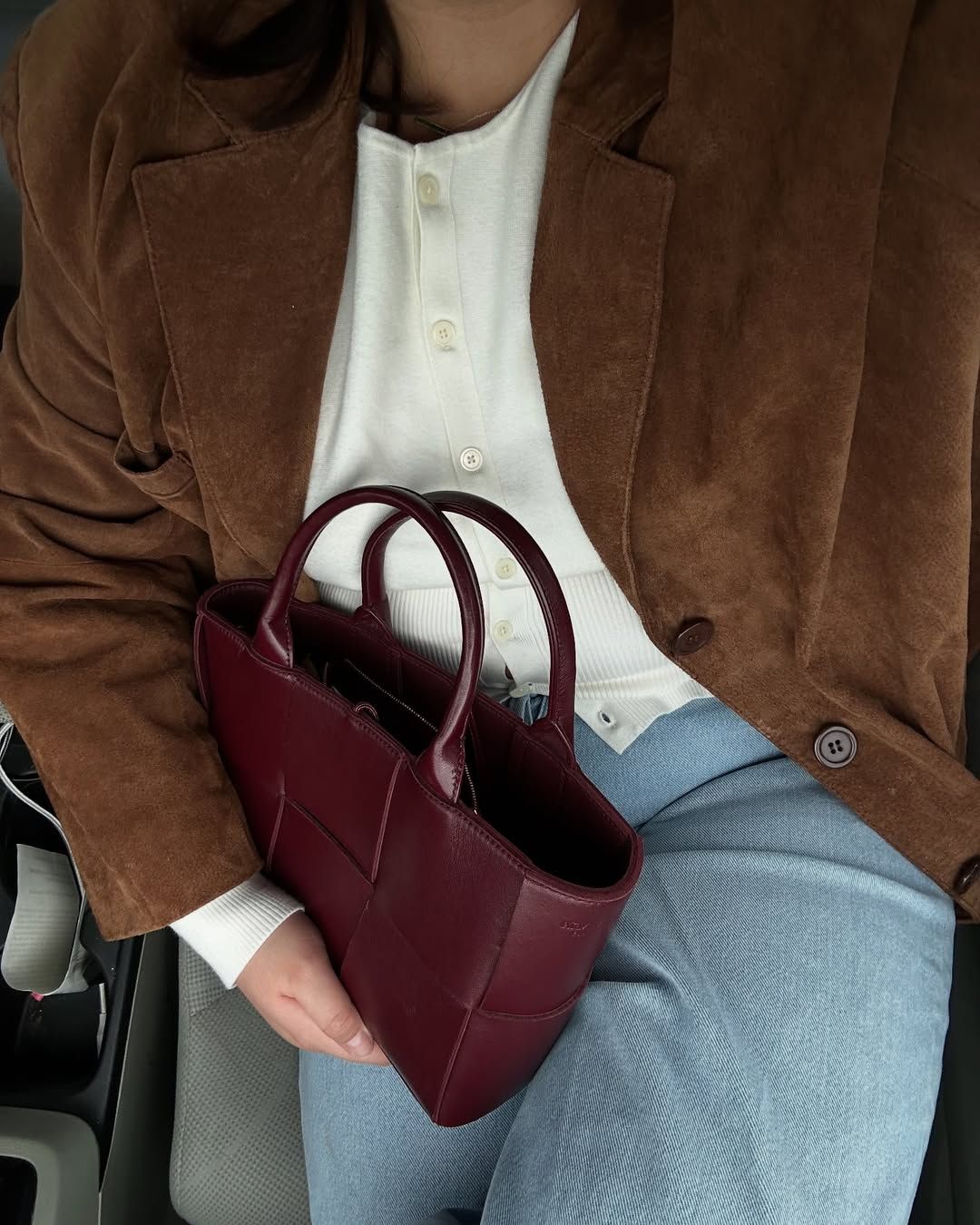 @marina_torres wearing suede jacket, cardigan and jeans