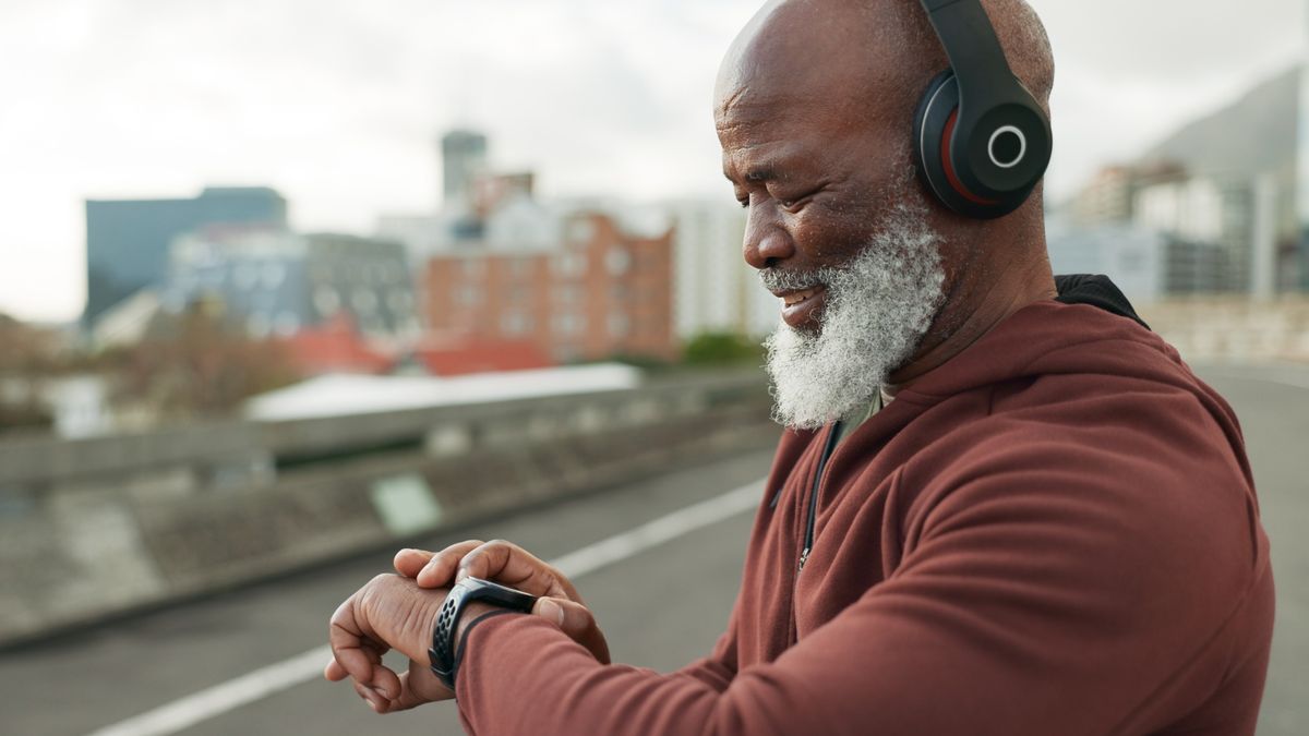 Senior man checking sports watch during workout