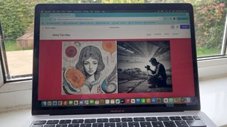 Person website on laptop in front of window onto garden