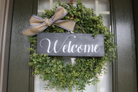 22" Round Farmhouse Faux Boxwood Wreath With Black and White Sign and Bow for $60, at Etsy