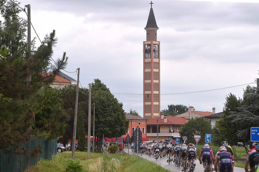 The peloton rides across the Italian countryside.