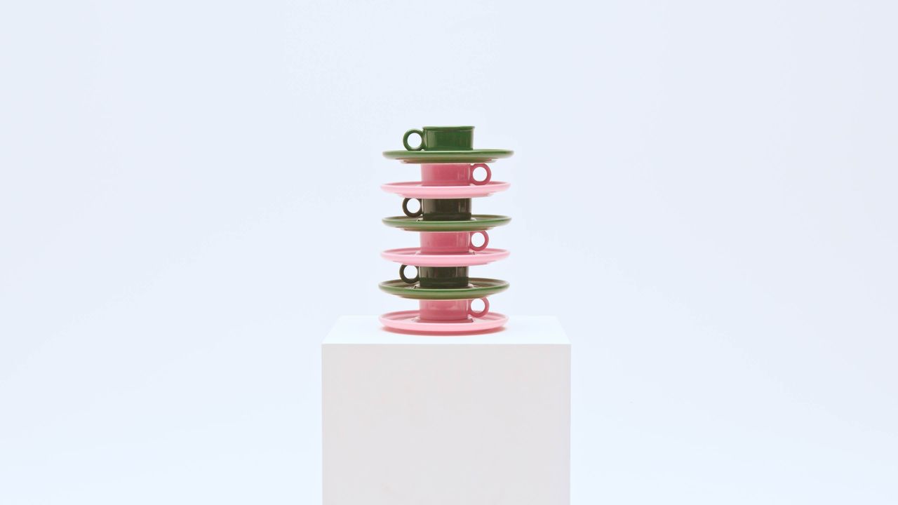 stack of pink and green porcelain teacups and saucers