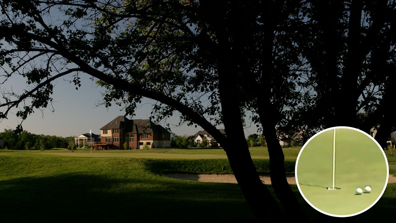 A clubhouse in the background of a golf course