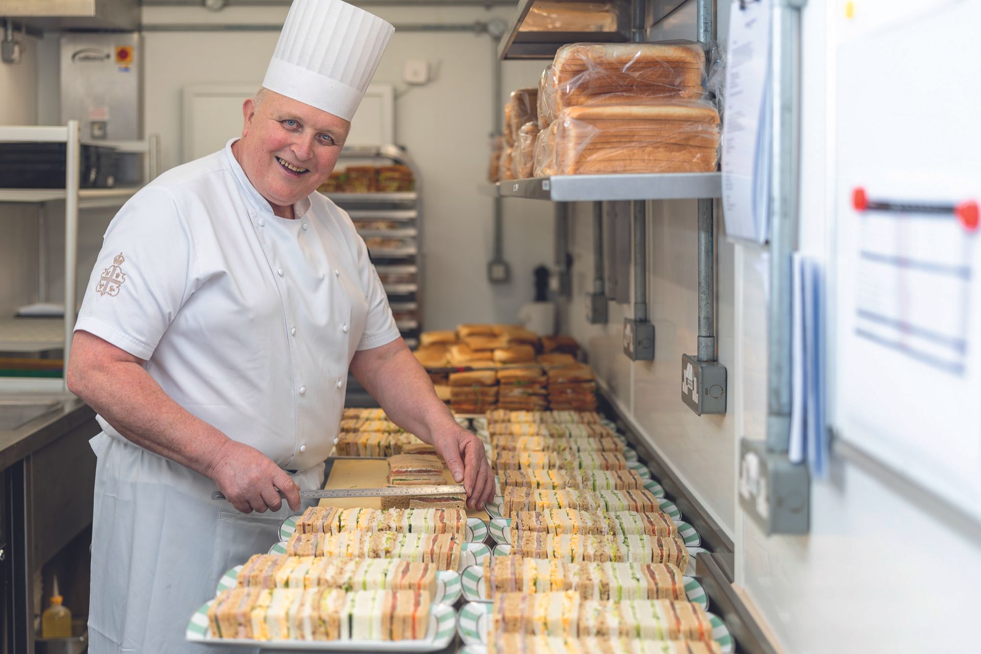 Volodmyr Tokaryk, sandwich maker, with loads of perfectly cut sandwiches and his special ruler