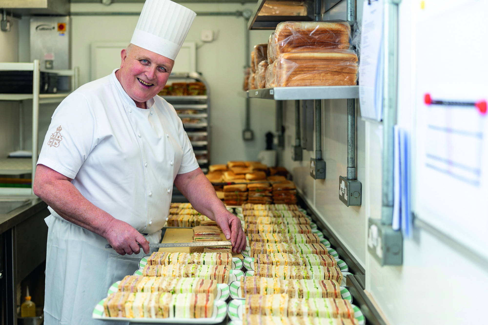 Volodmyr Tokaryk, sandwich maker, with loads of perfectly cut sandwiches and his special ruler