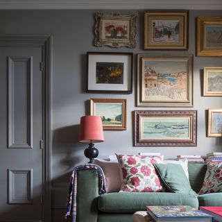 gallery wall of mixed artwork in a grey painted living room
