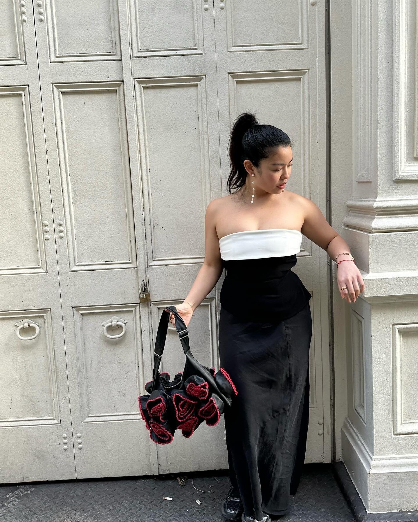 A woman wearing a strapless dress with an &quot;undone&quot; ponytail hairstyle