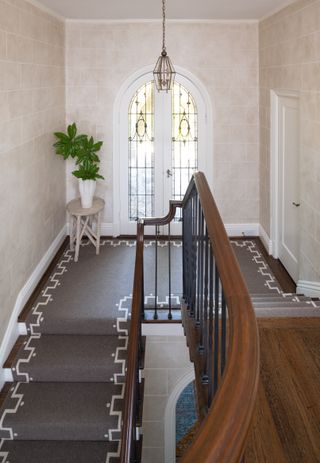 Staircase with brown runner with geometric pattern
