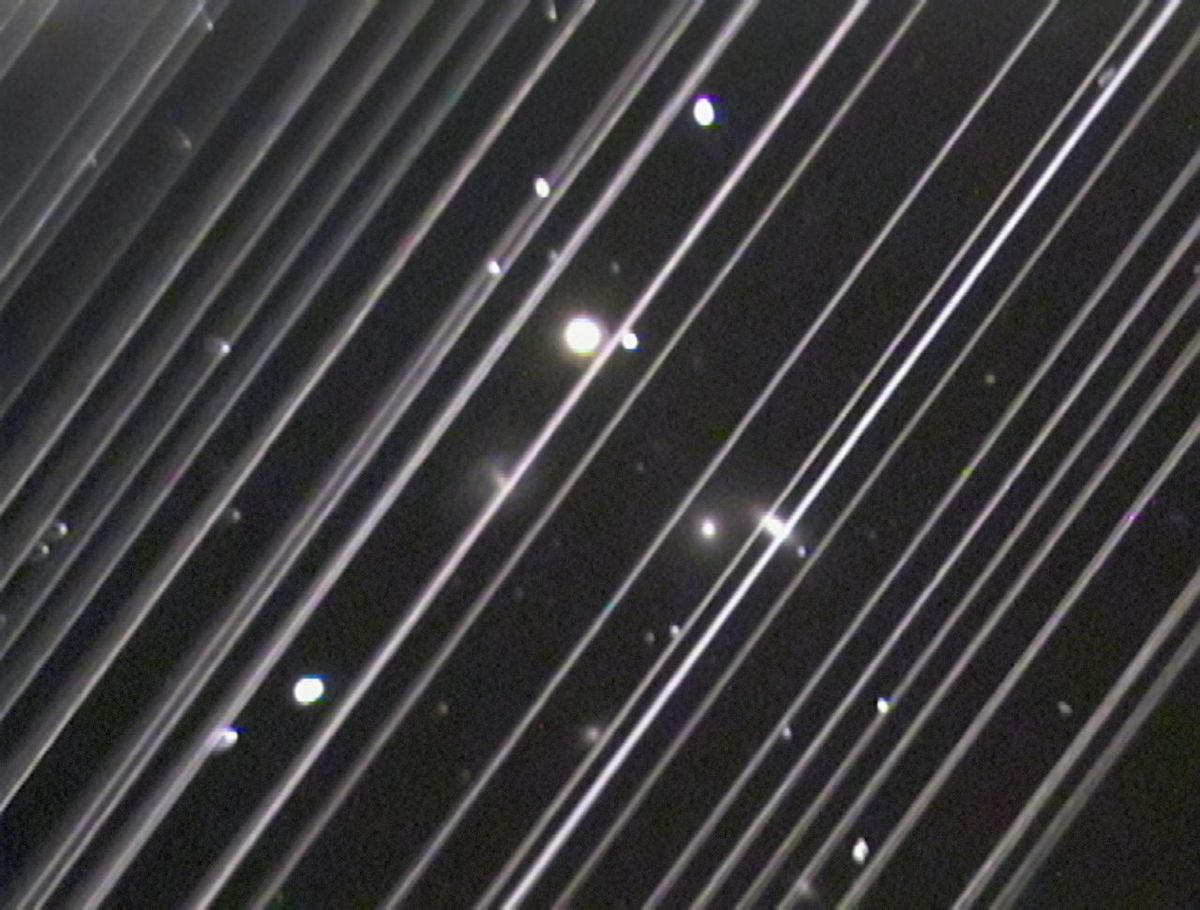 The diagonal lines stretching across this telescope image are reflected light from 25 of the first batch of Starlink satellites launched by SpaceX.