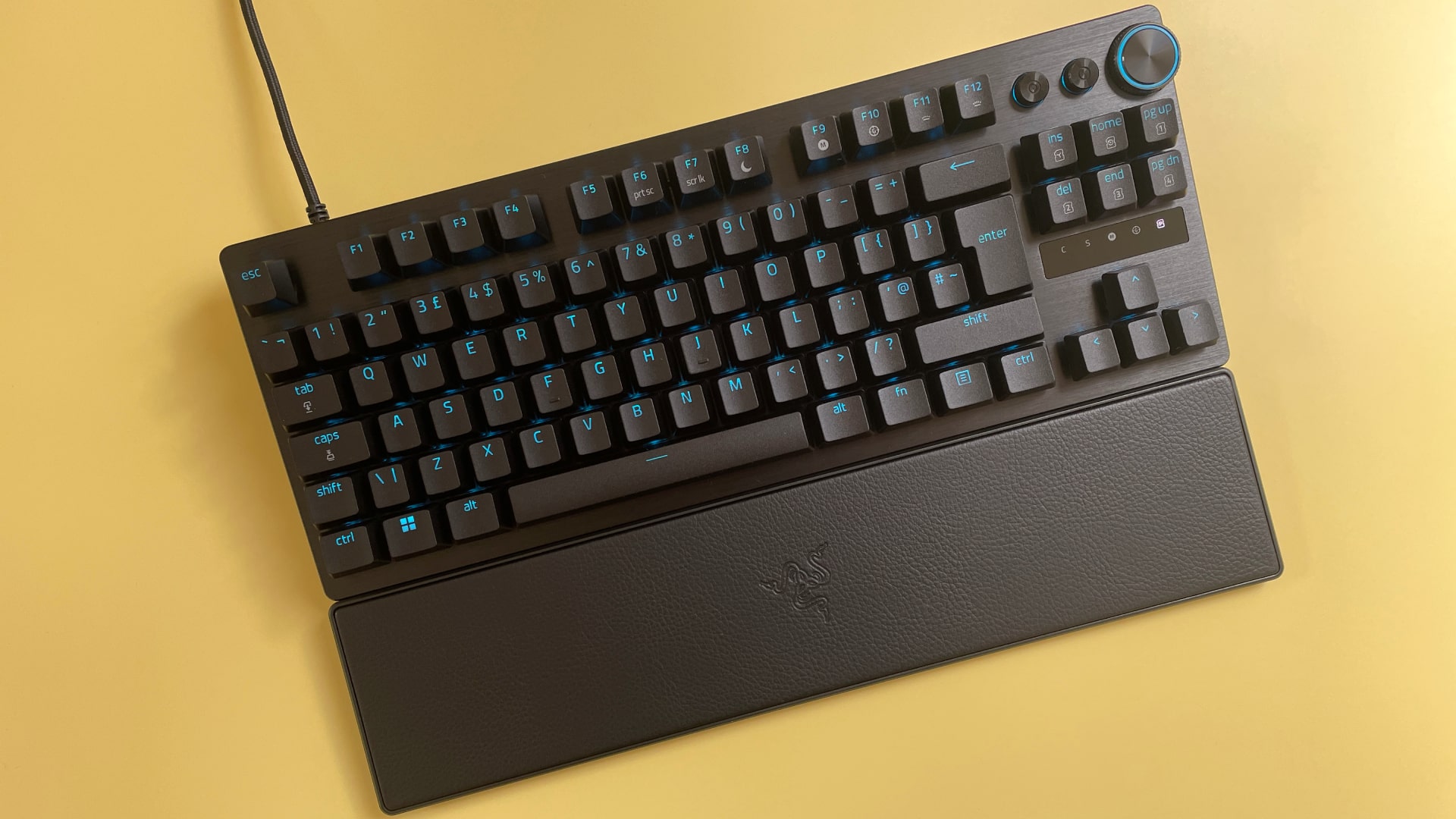 The Razer Huntsman V3 Pro Tenkeyless mechanical gaming keyboard against a yellow background.