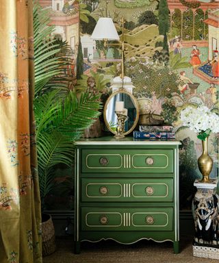 Green chest of drawers against maximalist wallpaper
