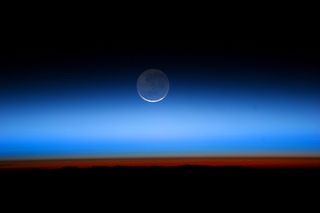 An image taken from the International Space Station in 2011 shows Earthshine on the moon.