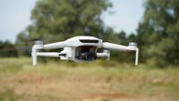 Potensic Atom 3 drone flying against background of trees