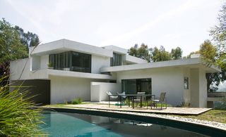 Exterior view of a swimming pool outside a house