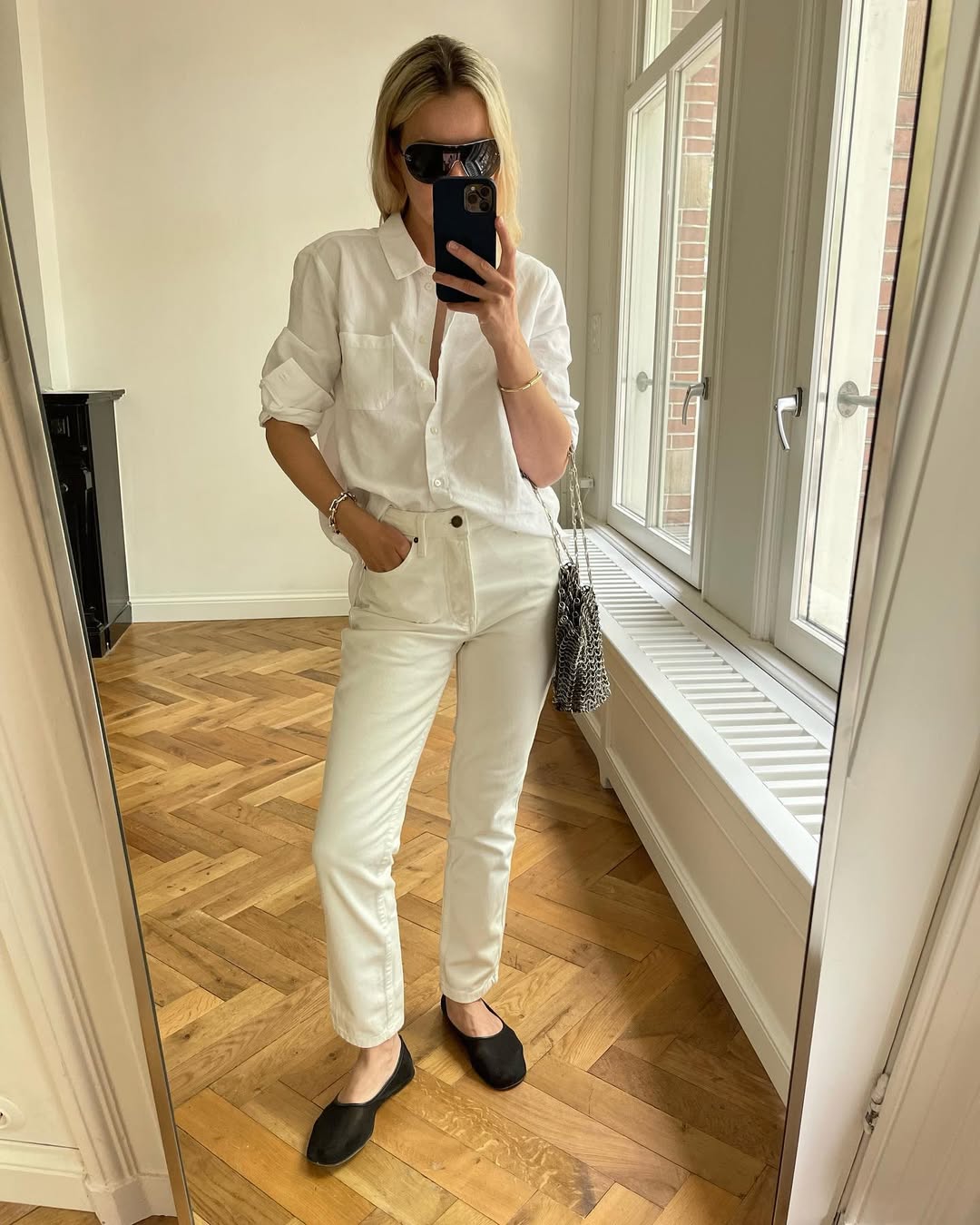 Woman wearing tailored jeans and ballet flats.