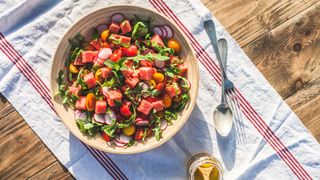 The best foods to eat in a heatwave - watermelon salad on outdoor table