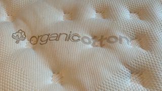 Image shows the top of the Saatva Classic mattress printed with the words 'organic cotton'