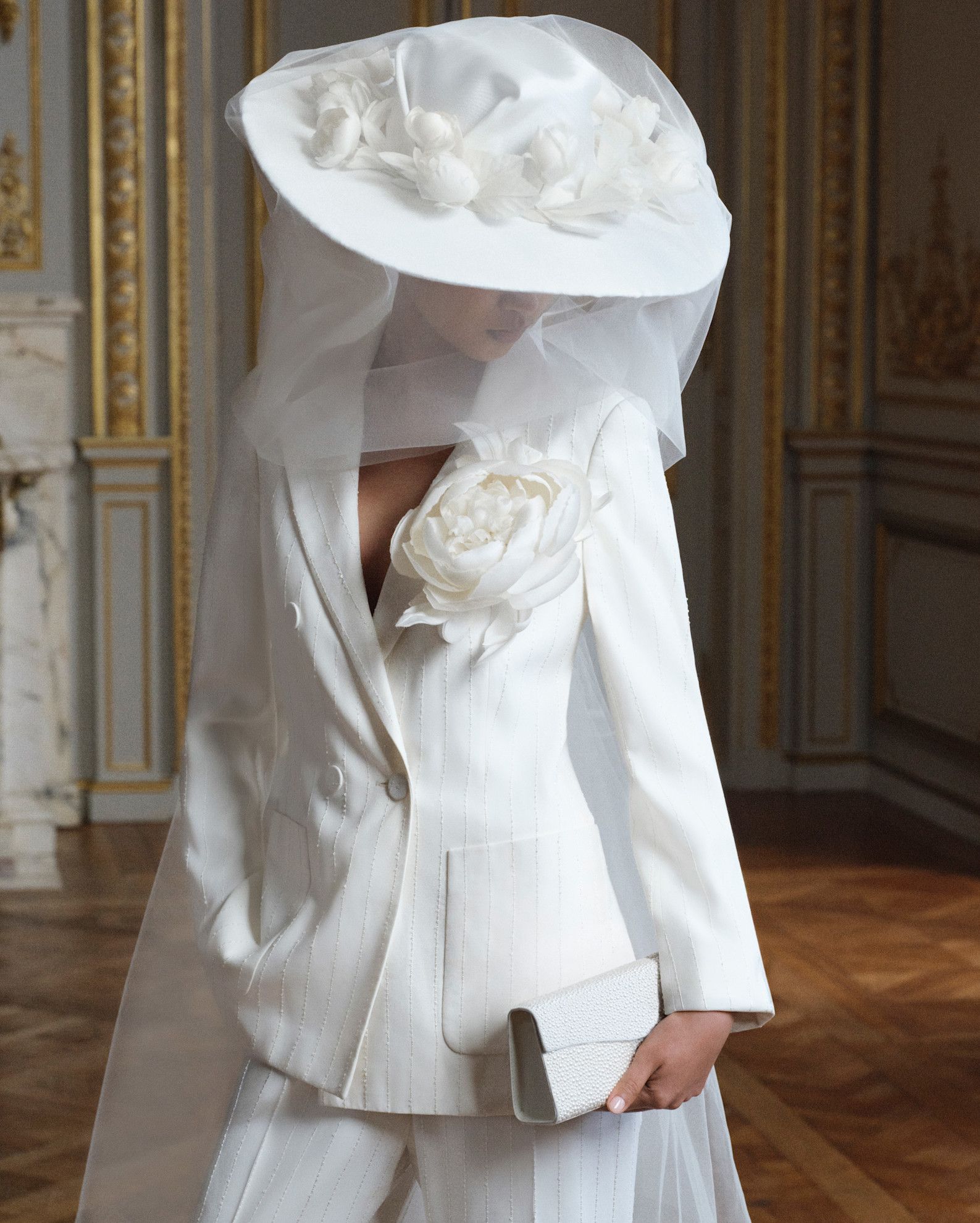 Woman wearing bridal hat, an emerging trend for 2026.