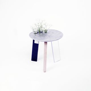 three legged stool with plants growing from it
