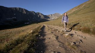 A woman walks along a trail on Grays Peak in Colorado