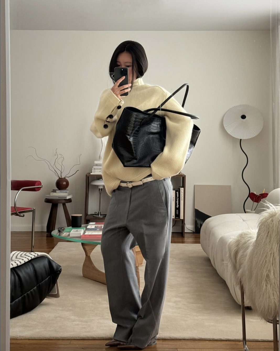 woman in yellow sweater and black tote bag