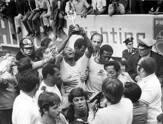 Pele (Edson Arantes do Nascimento) 1940 - Brazilian football player, 1994 Minister of Sports in Brazil - Celebrating Pele, surrounded by teammates, is raising the Jues Rimet Trophy after beating Italy in the final - June 1970