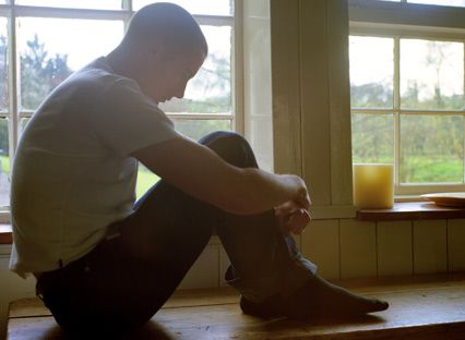 Depressed lonely man by window