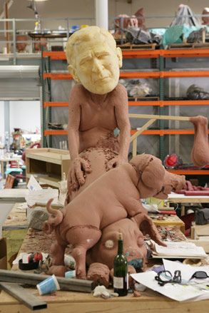 A sculpture with the face of George W. Bush committing buggery with a pig.