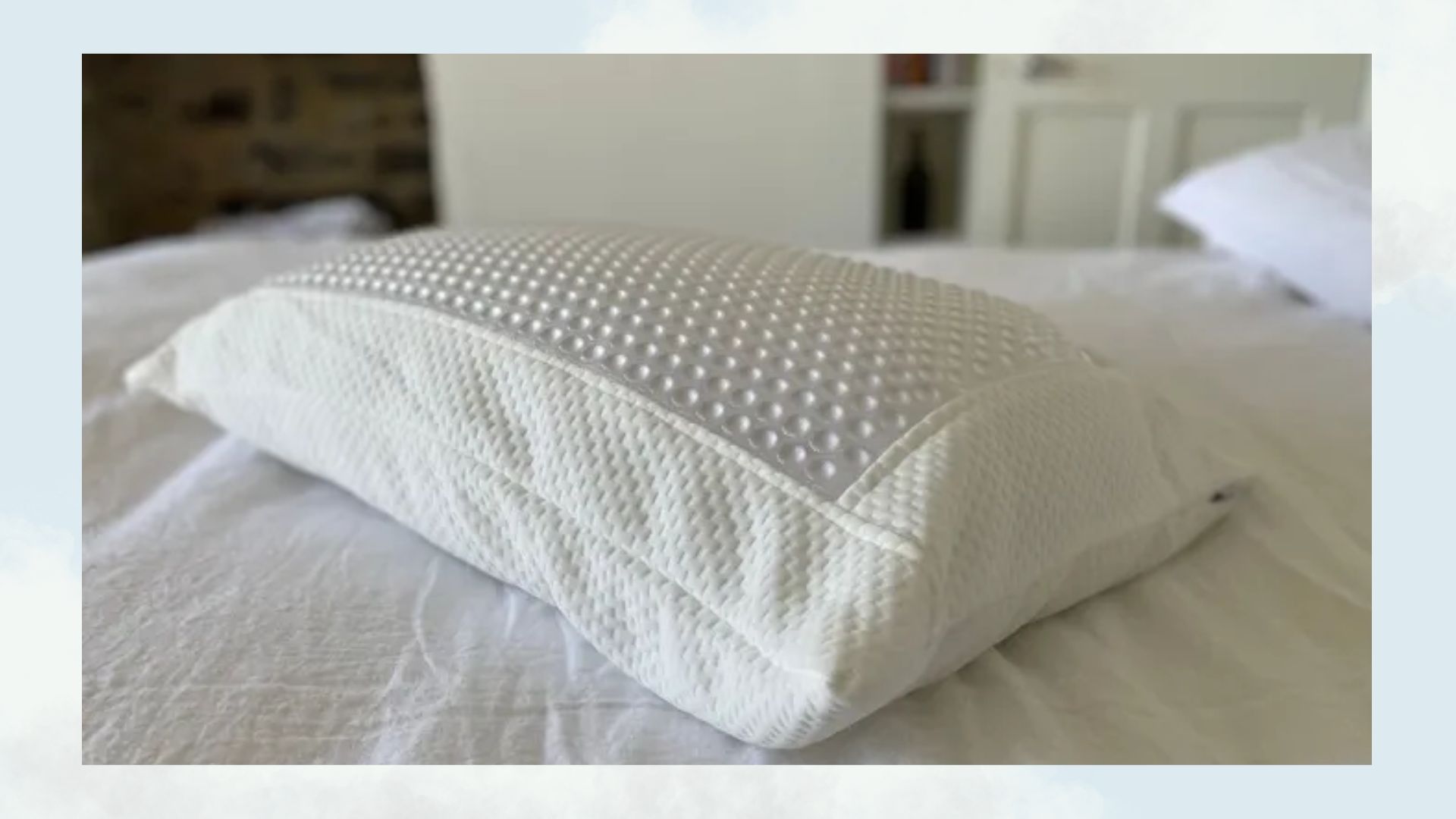 Silentnight cool touch pillow on a bed with a blue background and clouds